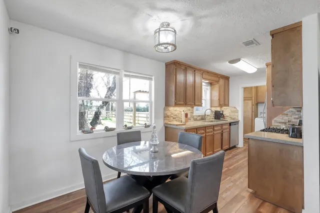 a view of a dining room with furniture and wooden floor