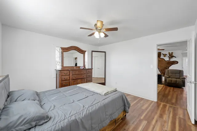a bathroom with a granite countertop sink mirror vanity and toilet