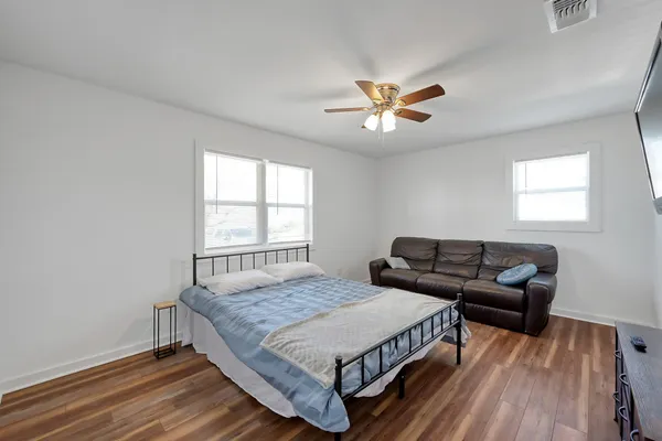 a bedroom with a bed and a flat screen tv