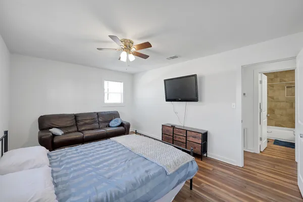 a bathroom with a sink toilet vanity and shower