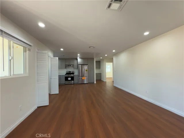 a view of a kitchen with a sink and a refrigerator