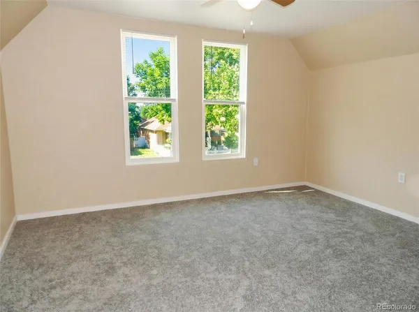 a large bed sitting in a bedroom next to a window