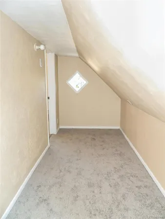 a view of a room with wooden floor and window