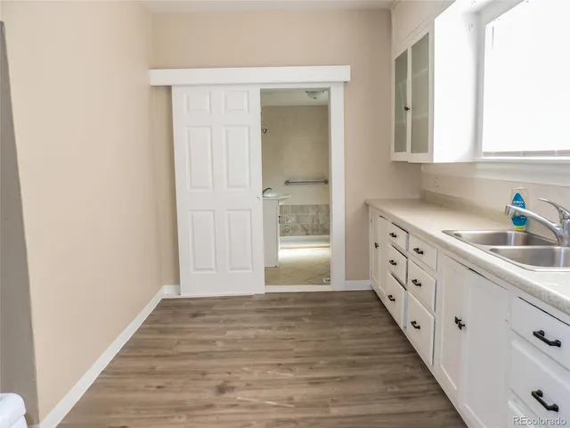 a spacious bathroom with a sink and a window
