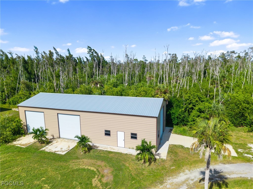 18181 Pioneer Road Fort Myers, FL 33908 - Photo 13 of 22 a aerial view of a house with table and chairs and wooden fence
