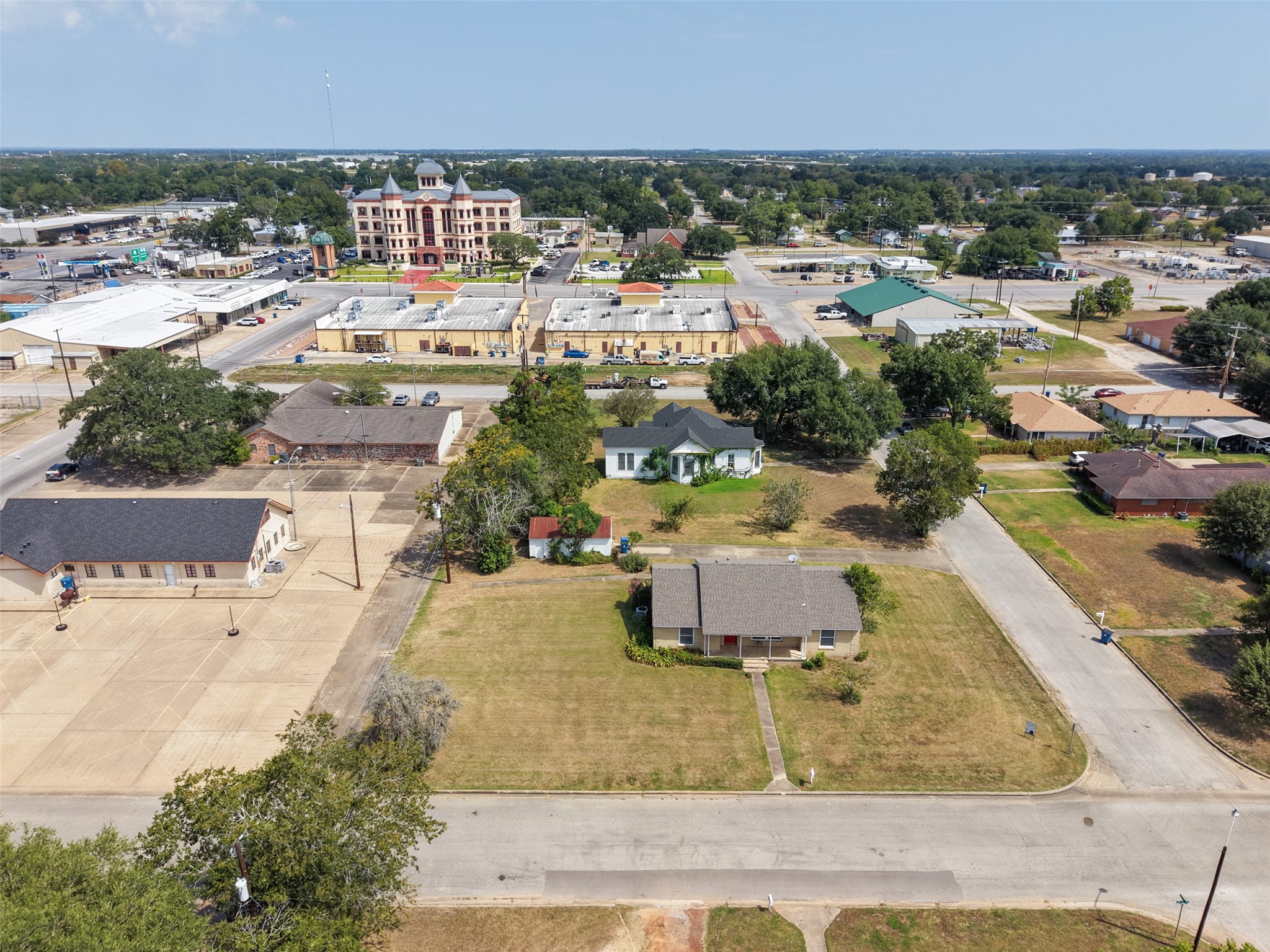 810 Main Street Hempstead, TX 77445 - Photo 7 of 32 Elevated view showcasing the property, generous yard space, and proximity to nearby businesses and community amenities.
