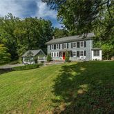 a front view of a house with a yard table and chairs