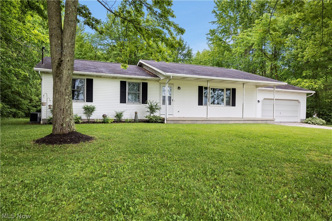 Ranch-style house with a garage and a front yard