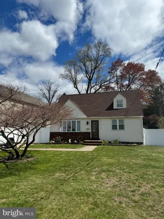 a front view of a house with a garden and yard