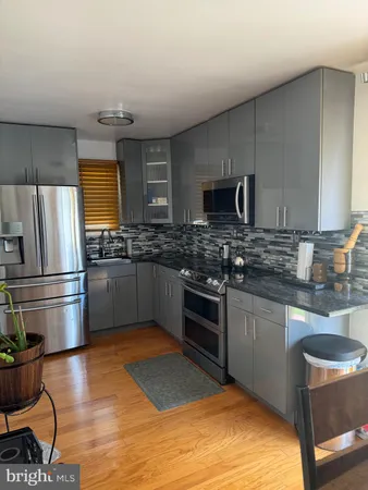 a kitchen with granite countertop stainless steel appliances and wooden cabinets