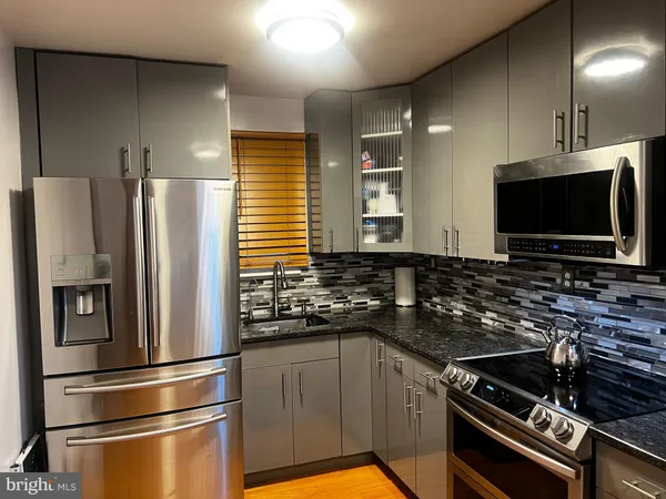 a kitchen with a refrigerator and a sink