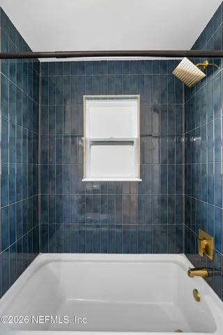 a bathroom with a bathtub and a shower