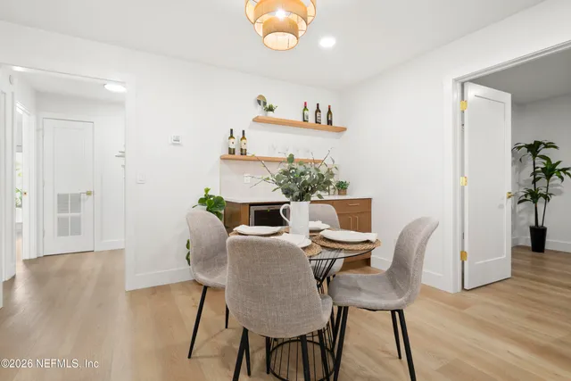 a view of a dining room with furniture and wooden floor