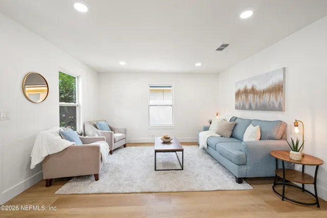 a living room with furniture and a lamp