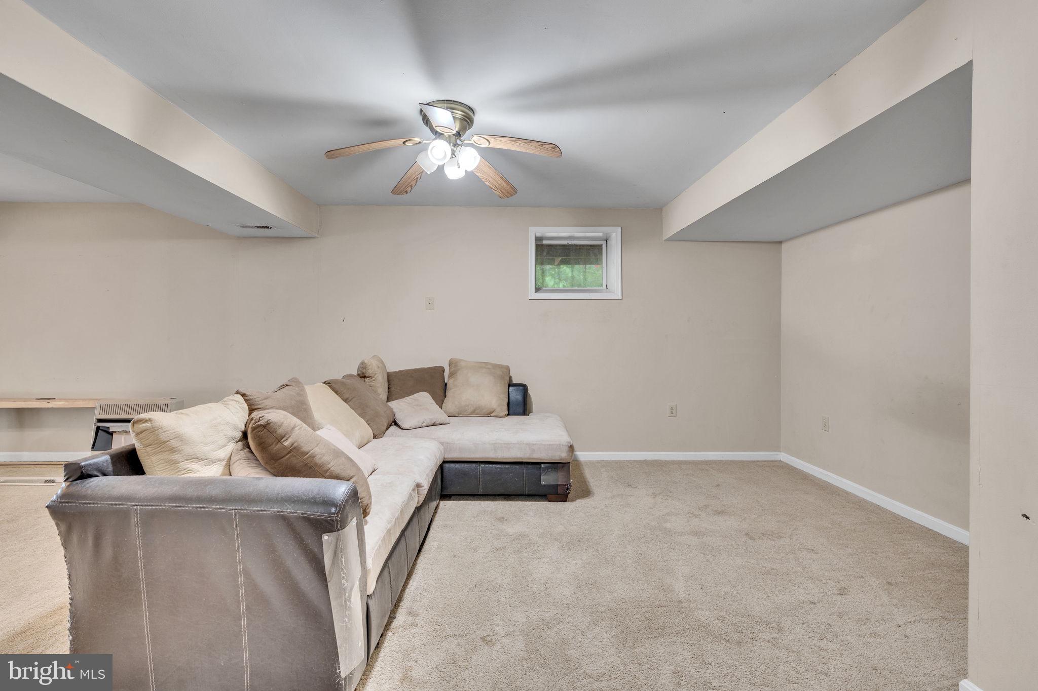 486 Round Up Road Lusby, MD 20657 - Photo 26 of 31 a living room with furniture and a ceiling fan