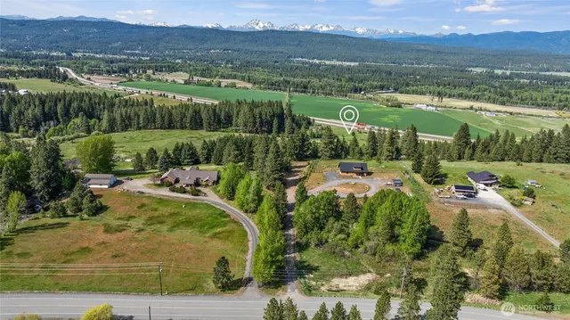 a view of a lush green hillside and houses