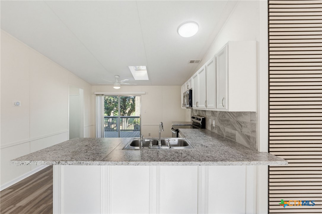 2739 Willow Loop Kempner, TX 76539 - Photo 9 of 30 a kitchen with granite countertop a sink and a window