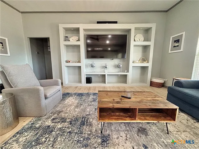a bathroom with a wooden floor and shower