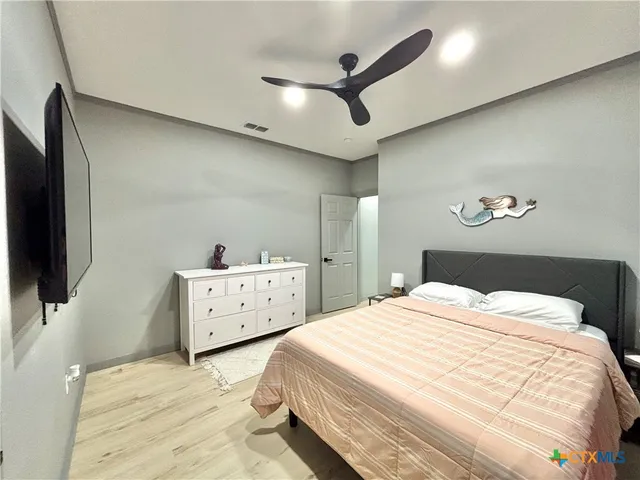 a bedroom with a bed and a night stand