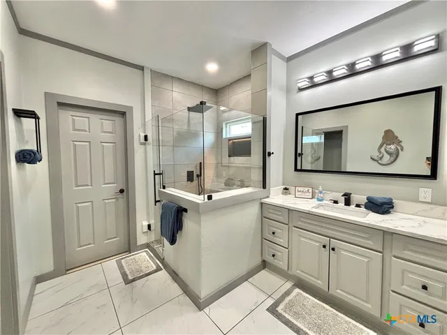 a spacious bathroom with a tub and shower