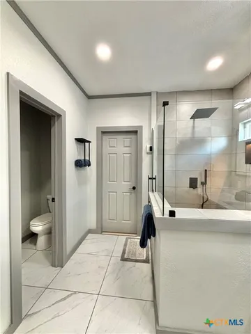 a building outdoor space with patio furniture and potted plants