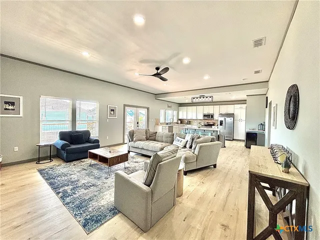 a living room with furniture and a wooden floor