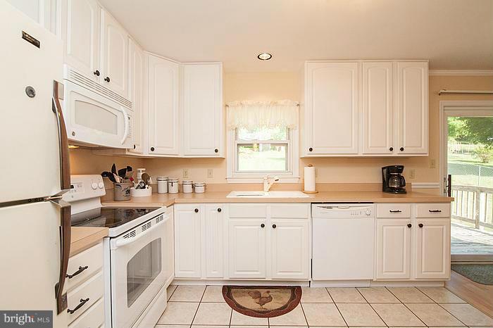 3244 Lineboro Road Manchester, MD 21102 - Photo 8 of 29 a kitchen with a sink a stove and cabinets