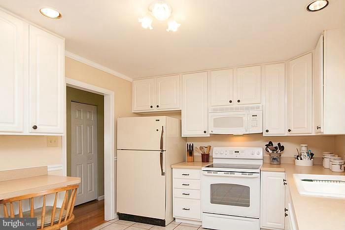 3244 Lineboro Road Manchester, MD 21102 - Photo 9 of 29 a kitchen with white cabinets and white appliances