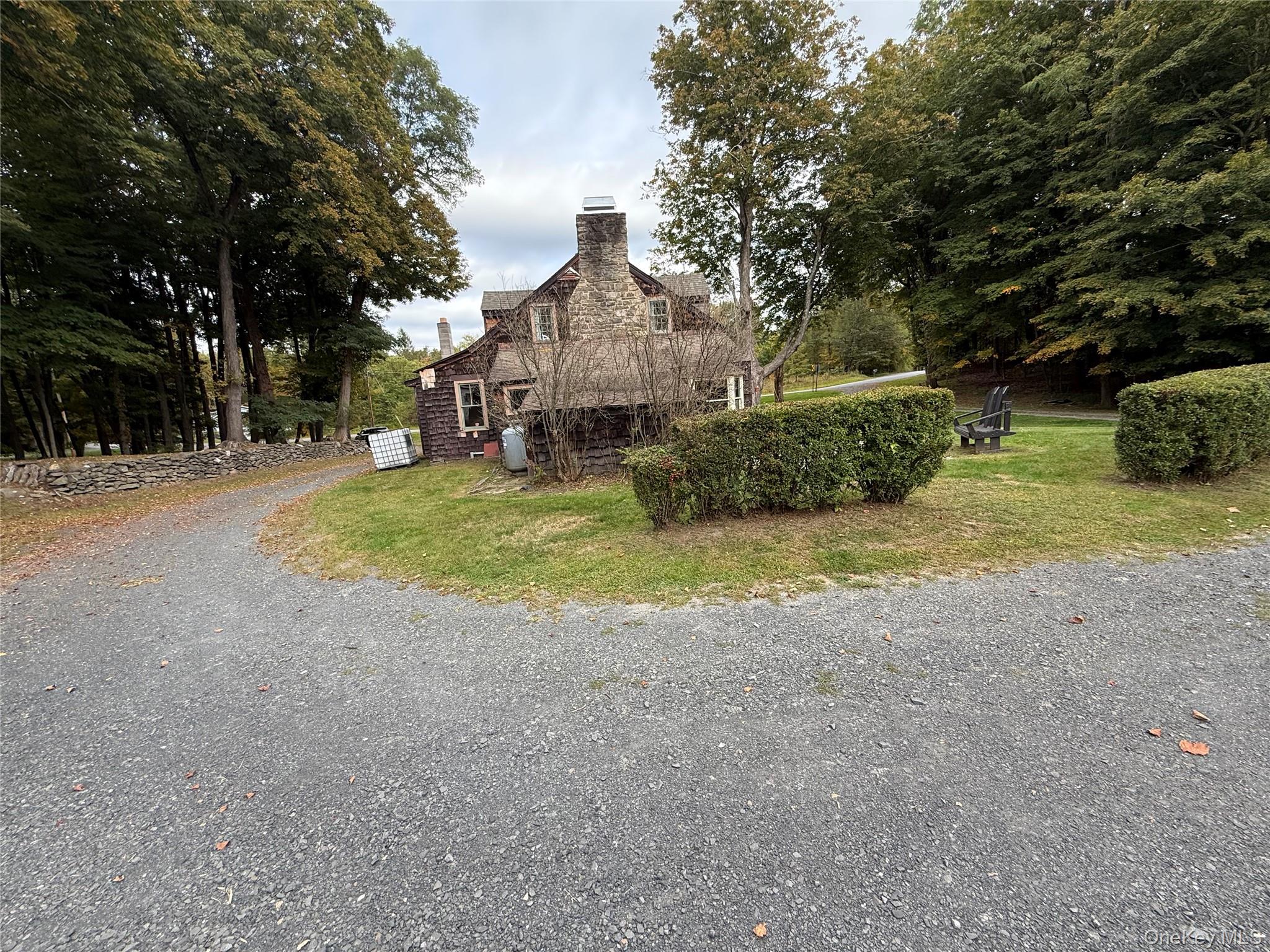 241 White Bridge Road Middletown, NY 10940 - Photo 3 of 29 View of home's exterior featuring a chimney, gravel driveway, and a lawn