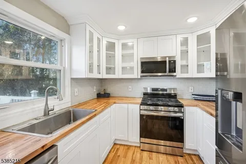 a kitchen with stainless steel appliances granite countertop a stove and a sink