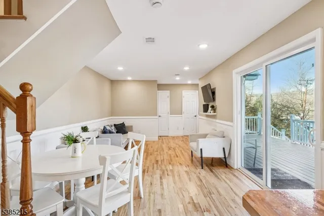 a view of a living room and floor to ceiling window or wooden floor