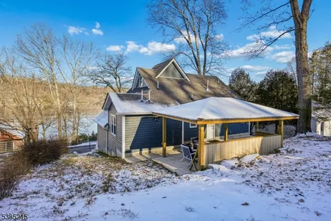 a view of a house with a yard covered in snow