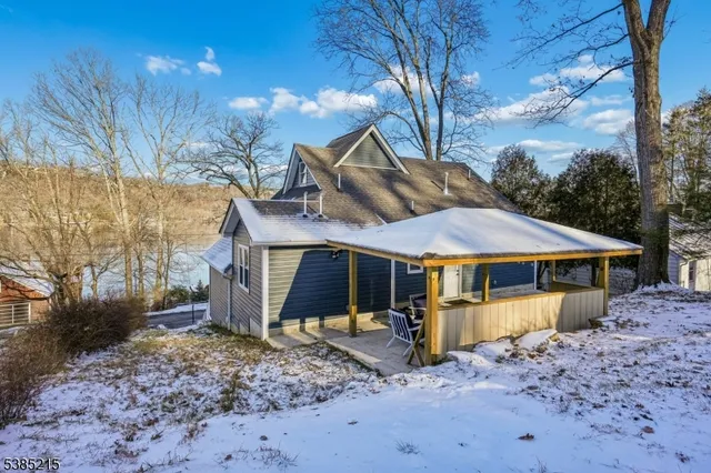 a view of a house with a yard covered in snow