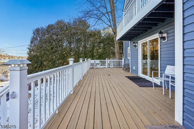 a view of backyard with deck and wooden floor