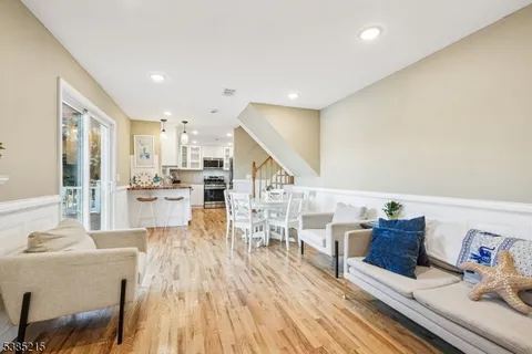 a living room with lots of furniture and kitchen view