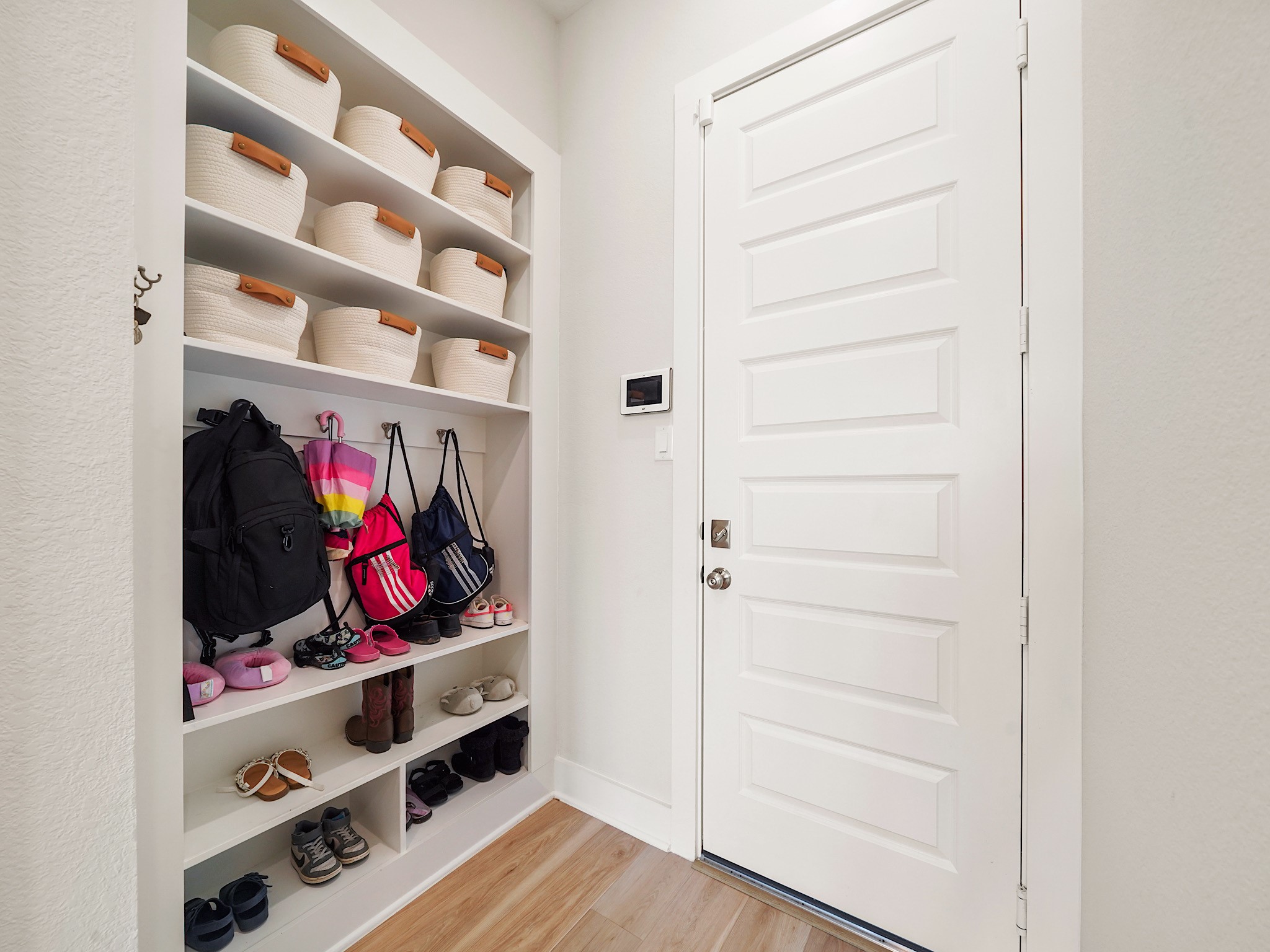 5802 Emerald Ranch Lane Fulshear, TX 77441 - Photo 29 of 45 Built-in storage near the utility area adds both style and functionality, offering the perfect drop zone for bags, shoes, coats, and everyday essentials.