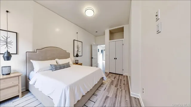 a bedroom with bed and wooden floor