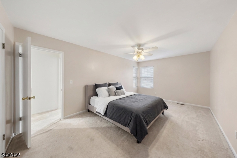 32 Rhea Run Newton, NJ 07860 - Photo 13 of 31 a bedroom with a bed and a chandelier
