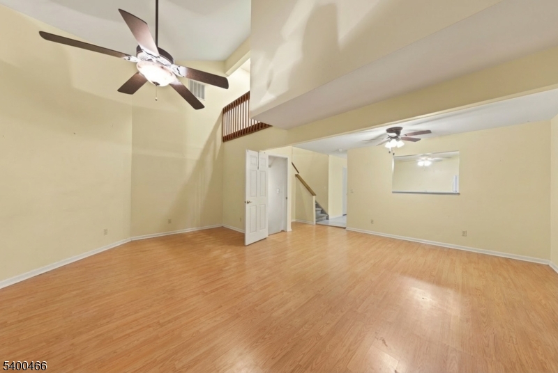 32 Rhea Run Newton, NJ 07860 - Photo 6 of 31 an empty room with a ceiling fan and wooden floor