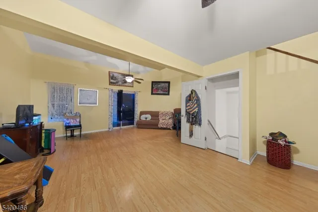 a view of a livingroom with furniture and a workspace