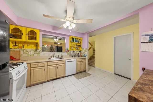 a large kitchen with a stove a sink dishwasher and a refrigerator