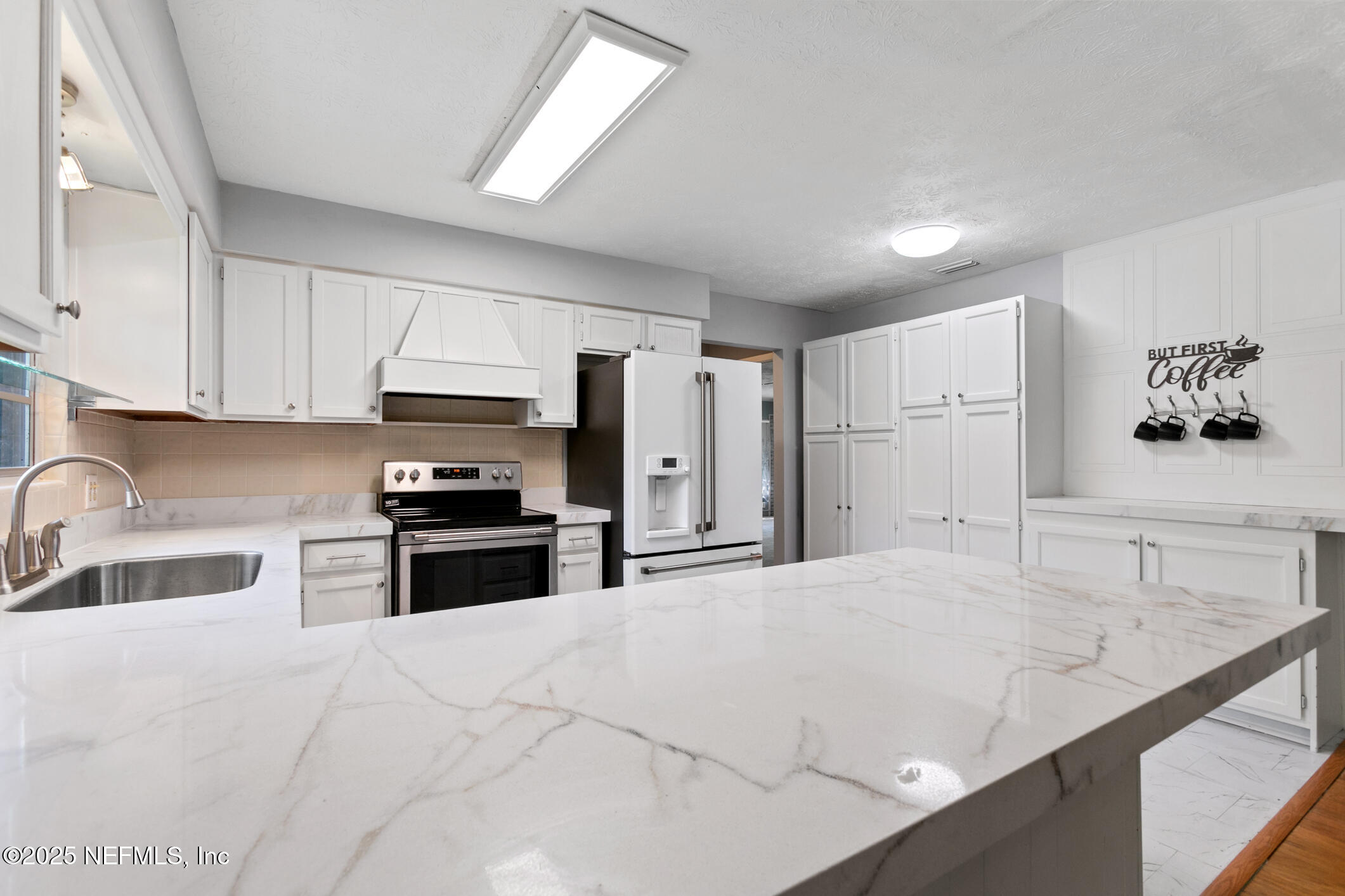 12657 Aladdin Road Jacksonville, FL 32223 - Photo 12 of 47 a kitchen with granite countertop a sink stove and refrigerator
