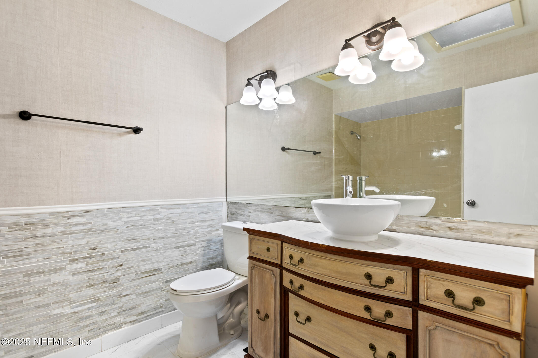 12657 Aladdin Road Jacksonville, FL 32223 - Photo 17 of 47 a bathroom with a sink a toilet and a mirror