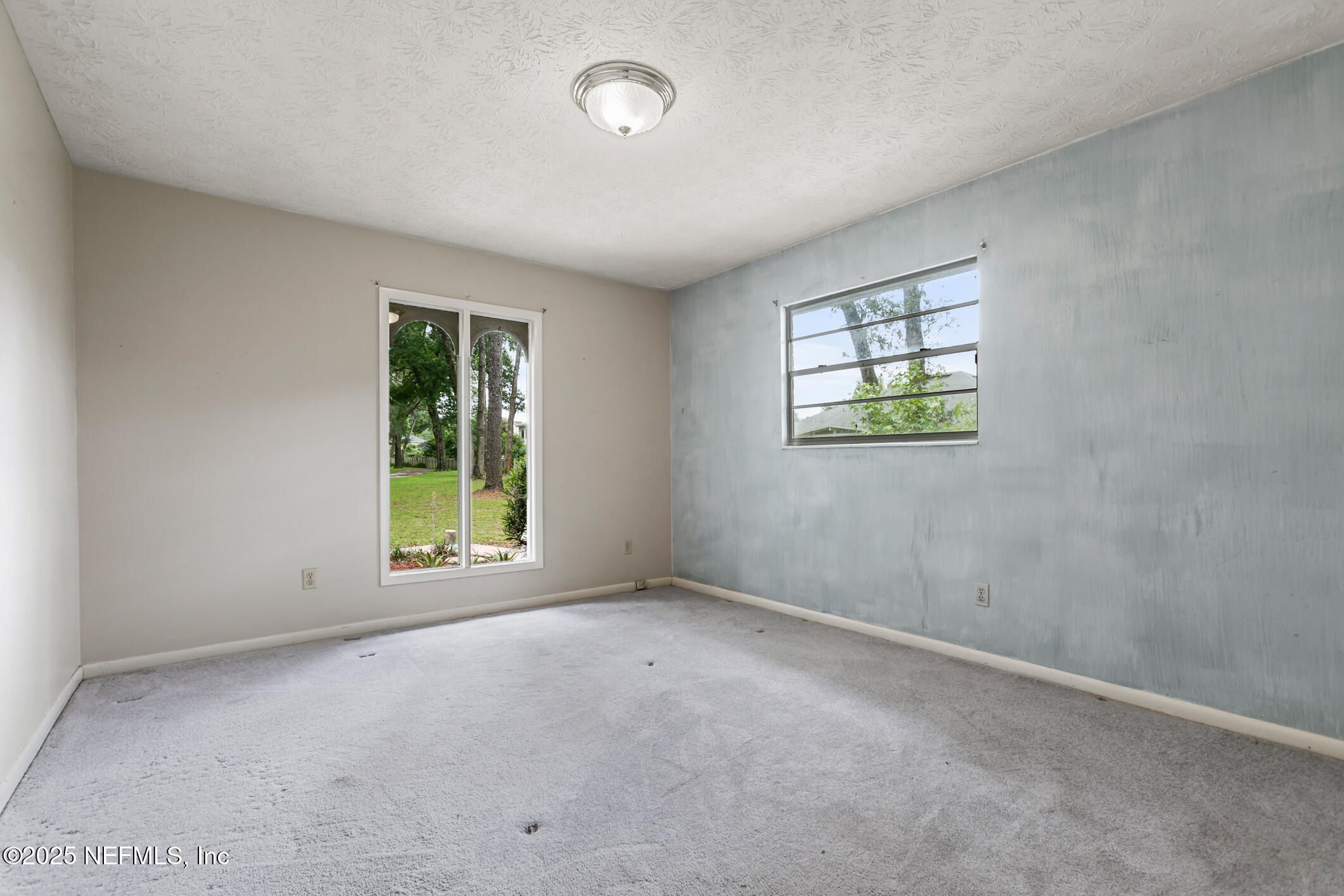 12657 Aladdin Road Jacksonville, FL 32223 - Photo 19 of 47 an empty room with windows