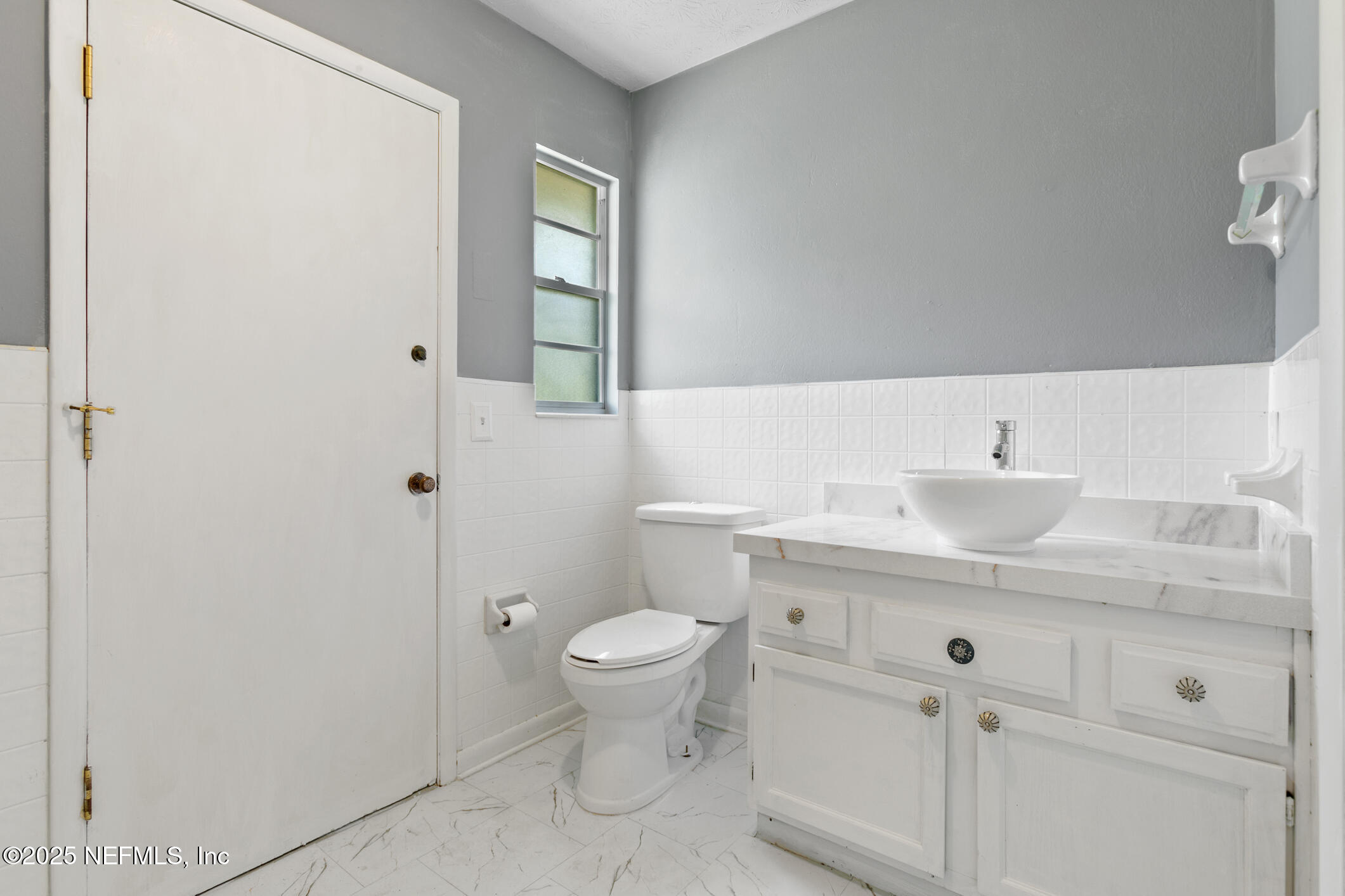 12657 Aladdin Road Jacksonville, FL 32223 - Photo 24 of 47 a bathroom with a sink a toilet and shower