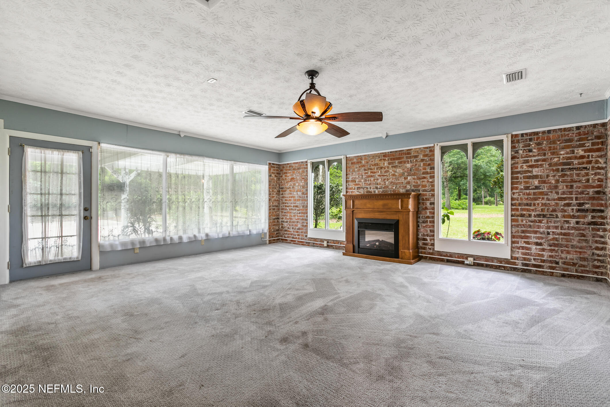 12657 Aladdin Road Jacksonville, FL 32223 - Photo 27 of 47 a view of an empty room with fireplace and a window