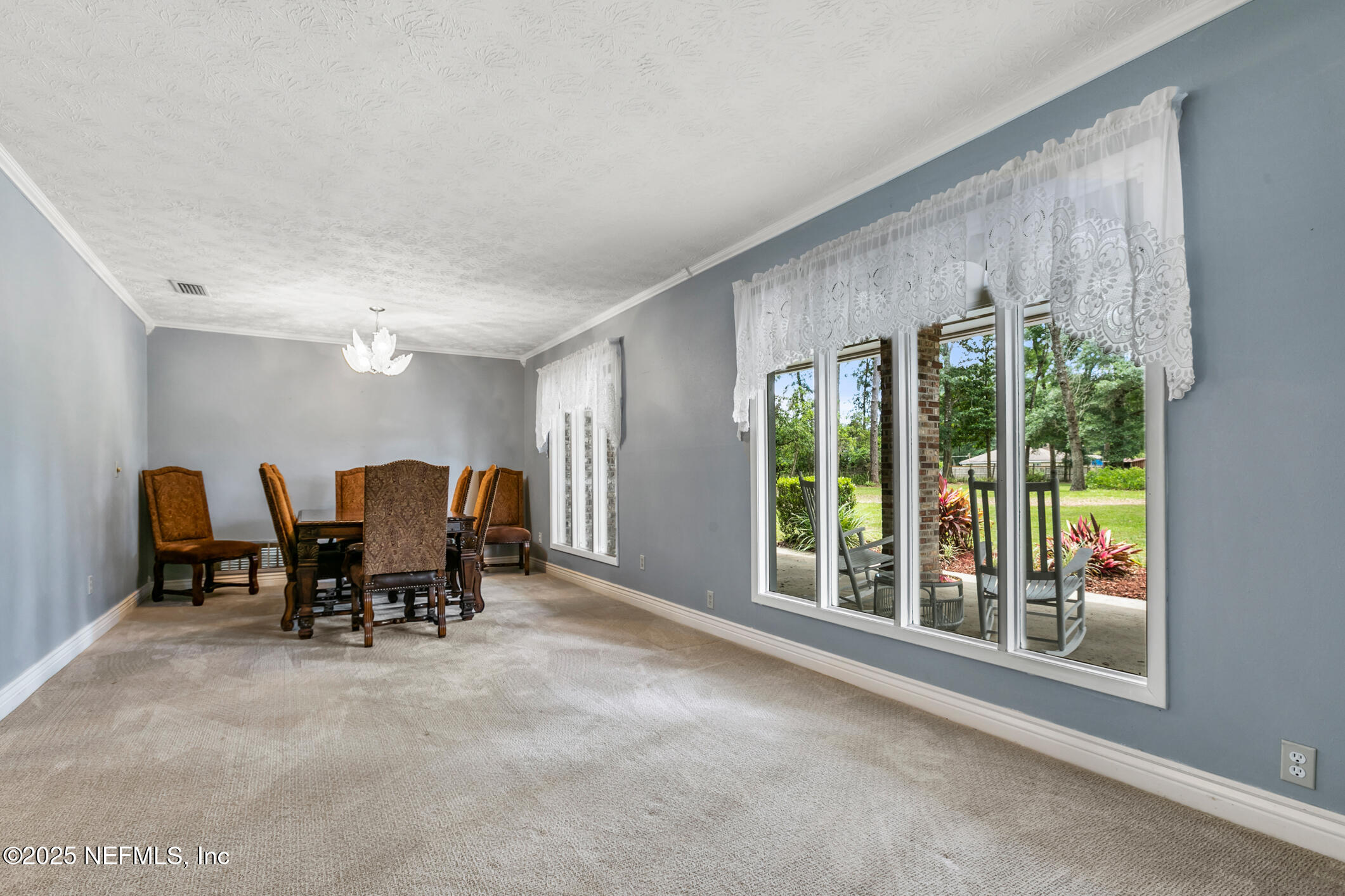 12657 Aladdin Road Jacksonville, FL 32223 - Photo 3 of 47 a view of a big room with furniture and floor to ceiling window