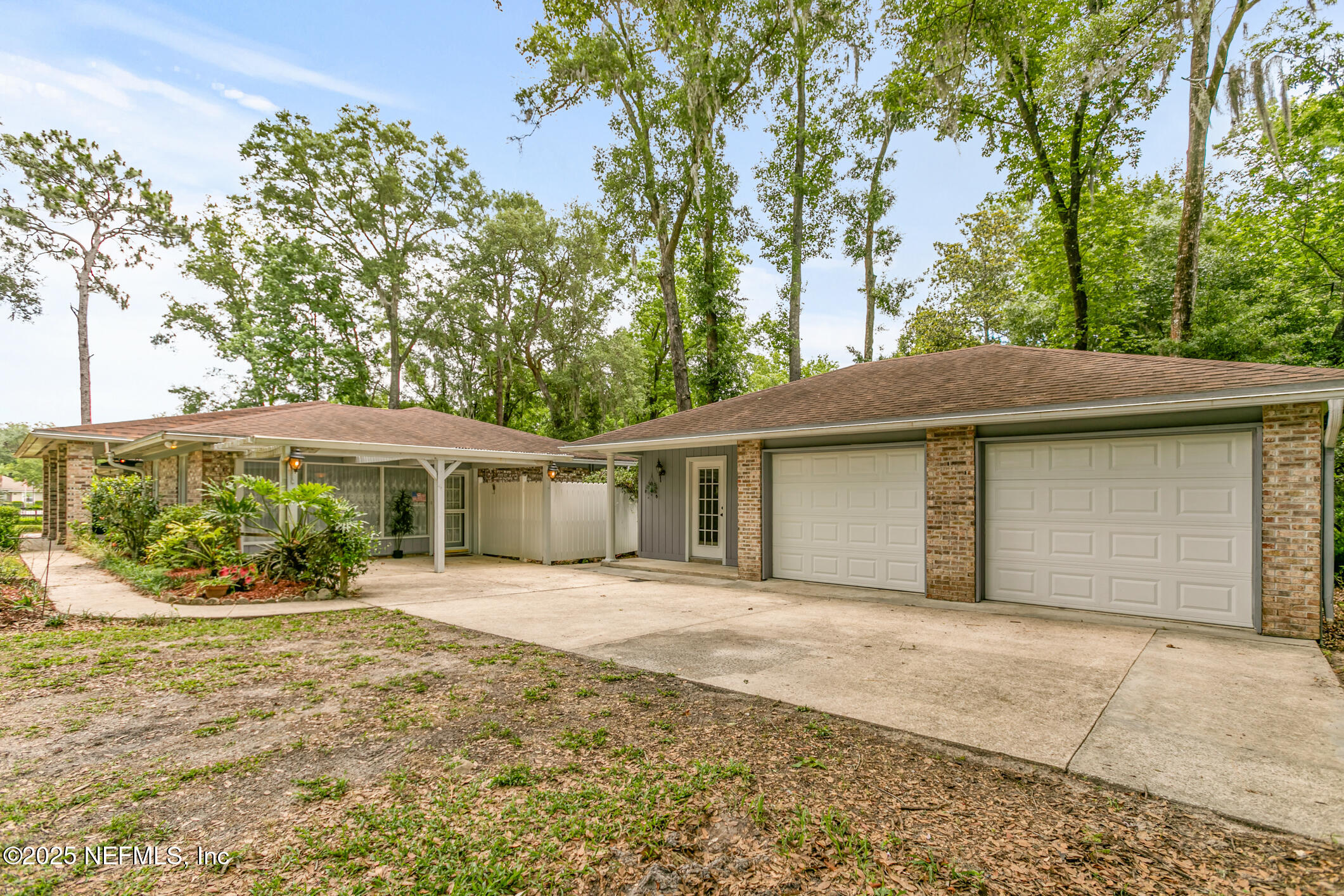 12657 Aladdin Road Jacksonville, FL 32223 - Photo 37 of 47 a front view of a house with a yard and potted plants