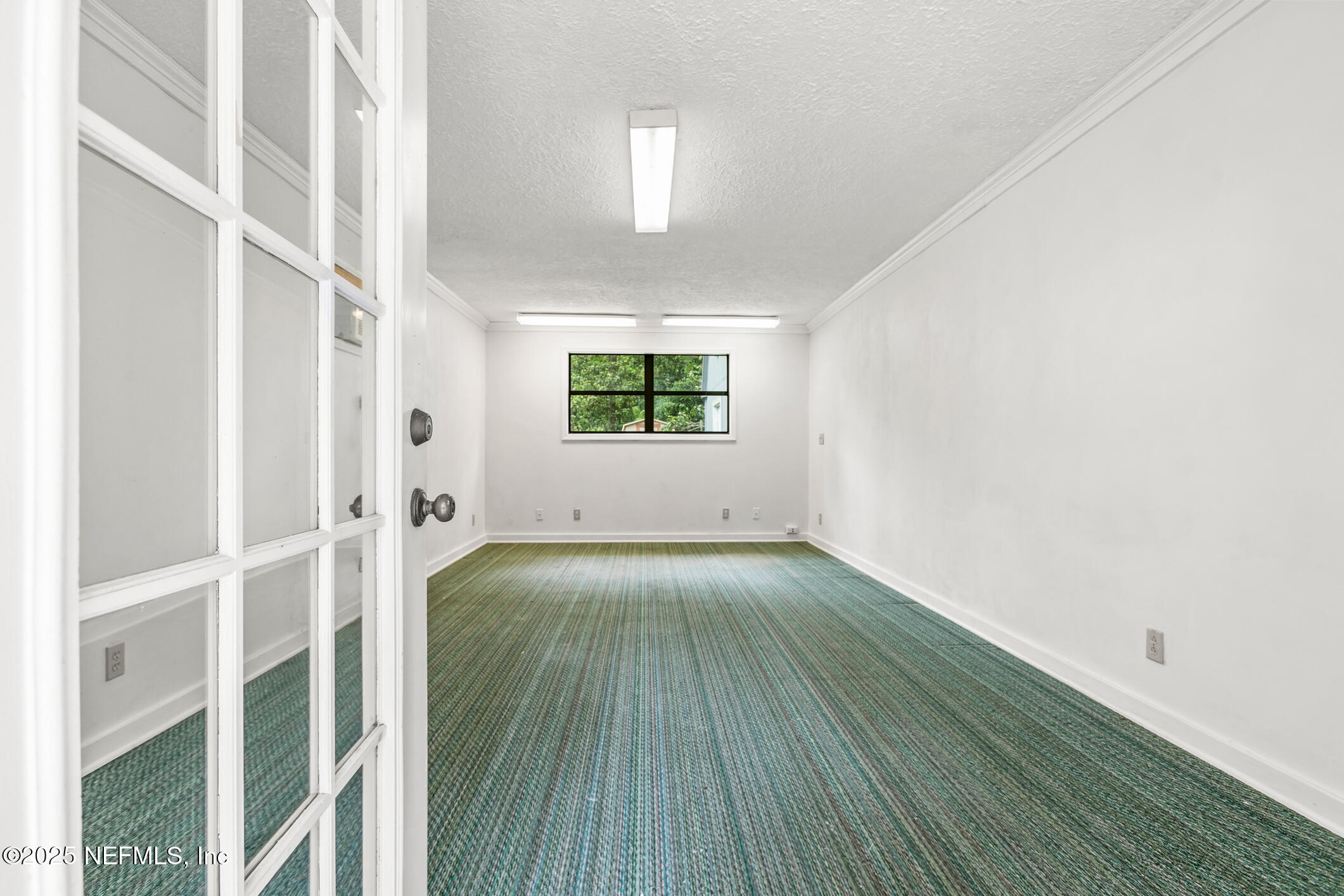 12657 Aladdin Road Jacksonville, FL 32223 - Photo 40 of 47 an empty room with wooden floor and windows