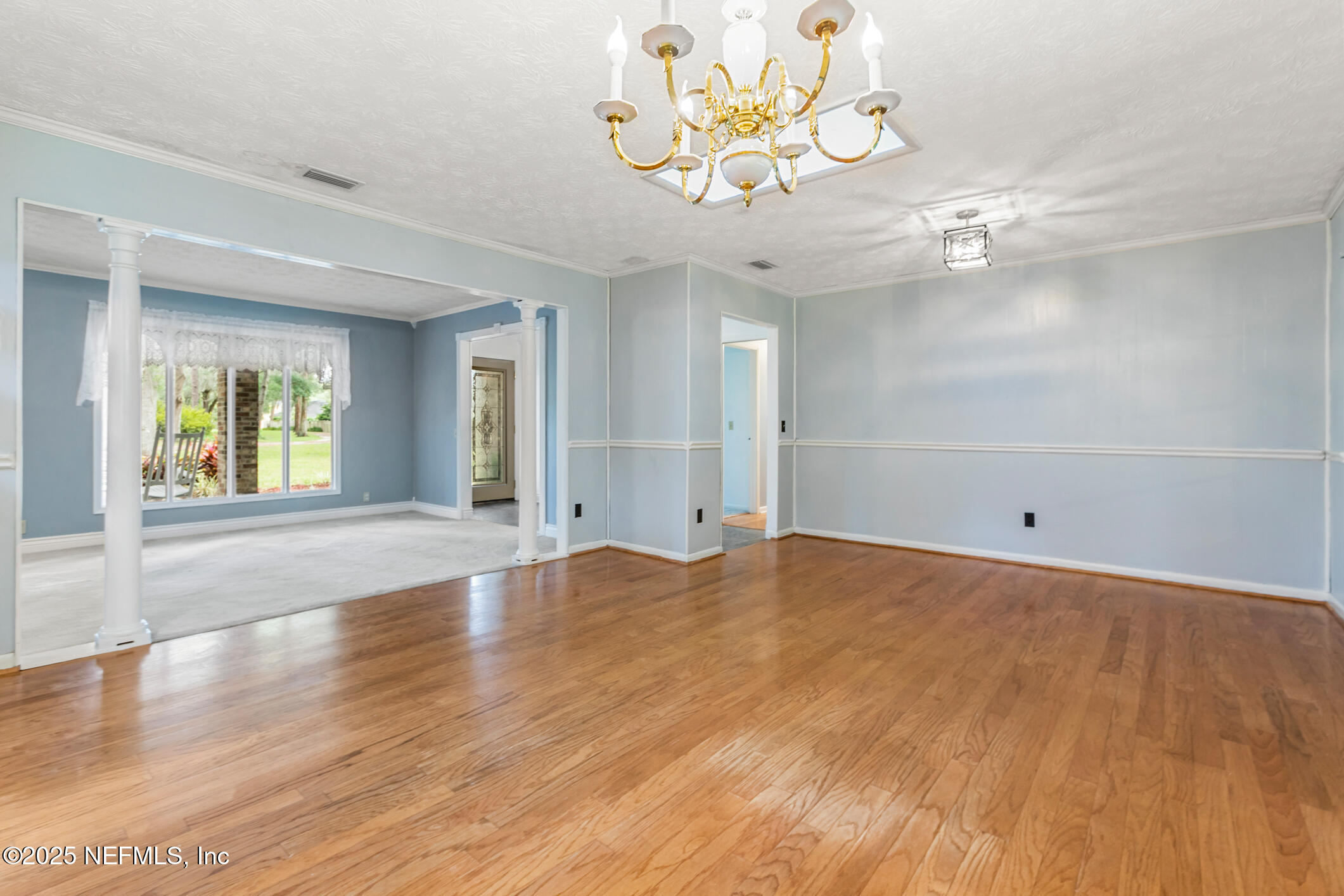 12657 Aladdin Road Jacksonville, FL 32223 - Photo 7 of 47 wooden floor in an empty room with a window